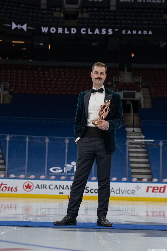 James Grant poses with the trophy at centre ice of the home of the Toronto Maple Leafs. It's nice, because that ice surface doesn't normally host trophy celebrations at centre ice.