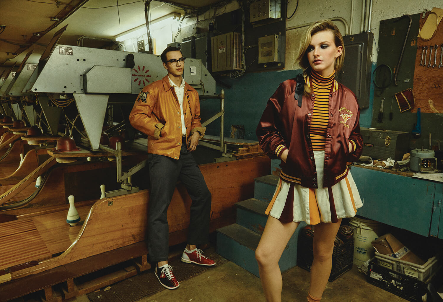 2ModelsBehindBowlingPins_WomanInCheerWardrobe