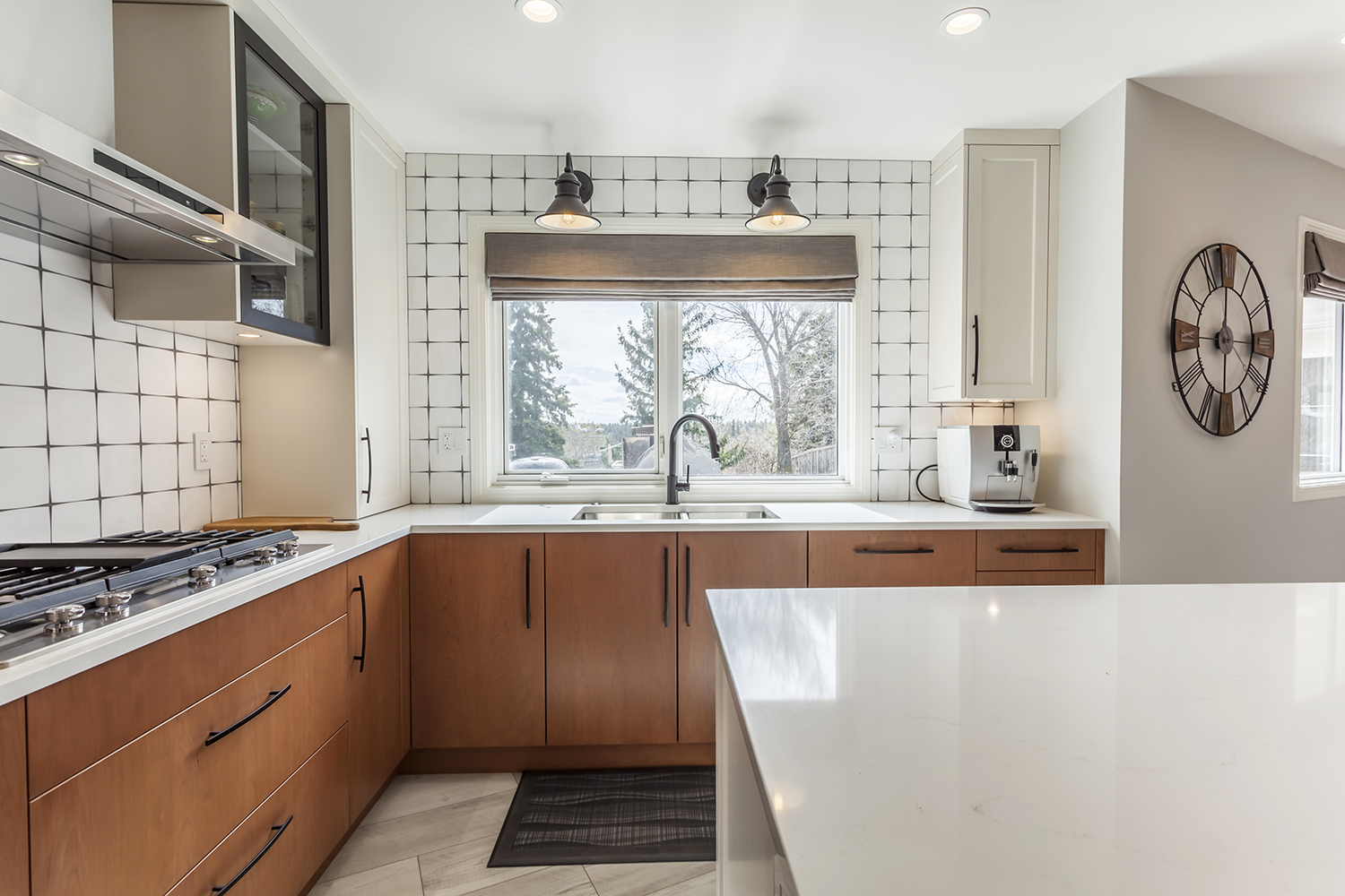White backsplash tiles brighten the kitchen.