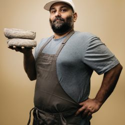 Aditya Raghavan, Chef and Owner of Fleur Jaune Cheese, holding a wheel