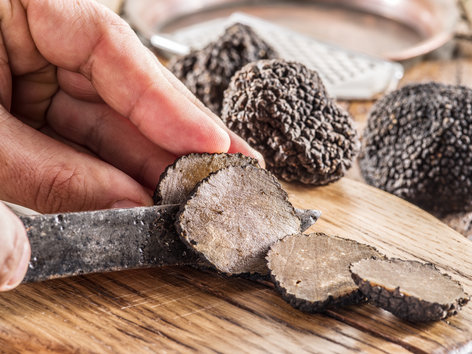 Black truffles on the old wooden table.
