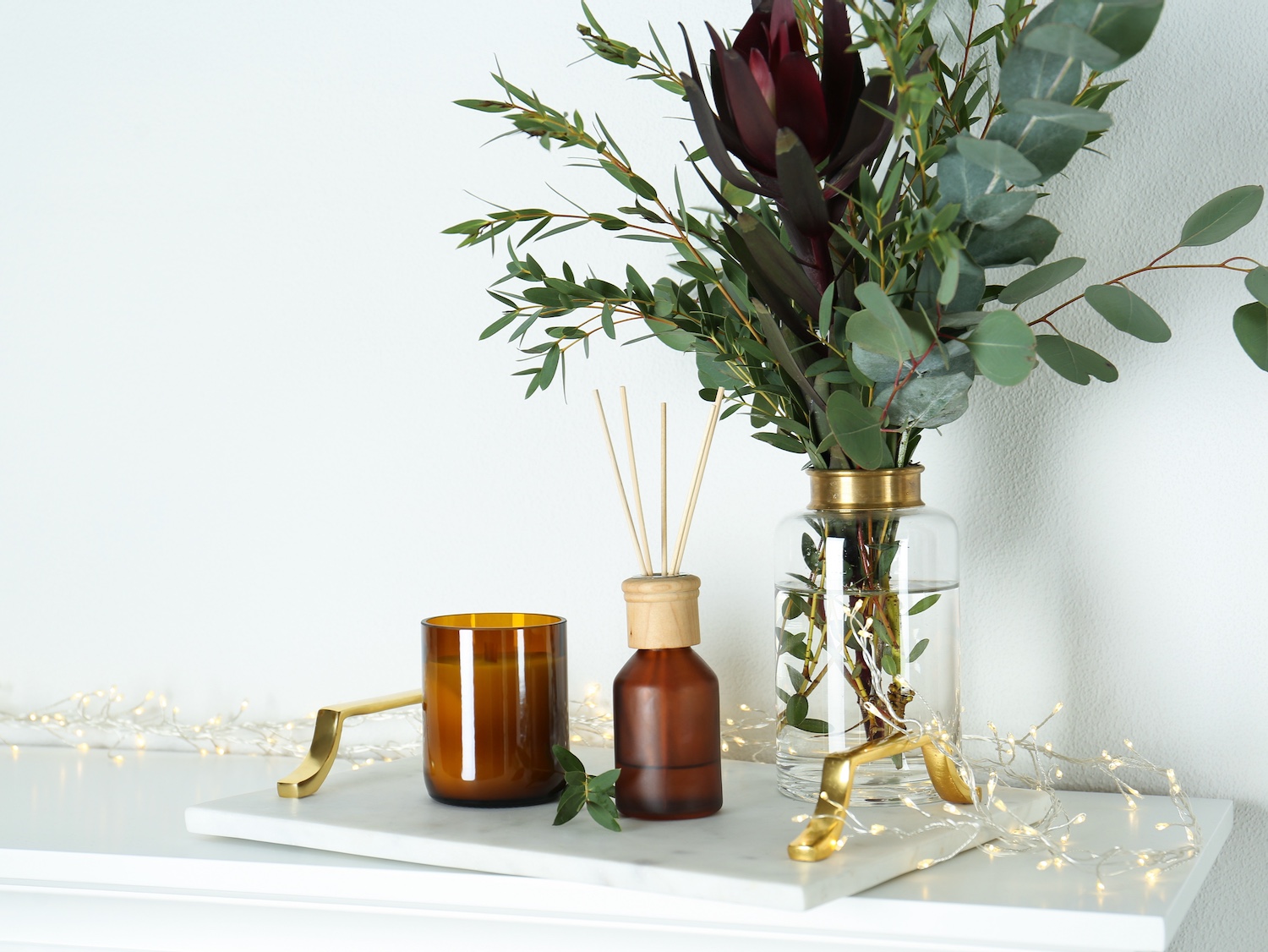 Candle and bouquet on a marble tray