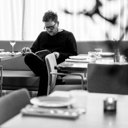 BR_Olia_BW_Man Sitting on BenchSeat Reading