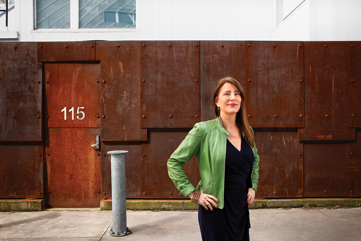 CatherineWarren_MintLeatherJacket_Standing_HandsOnHips_