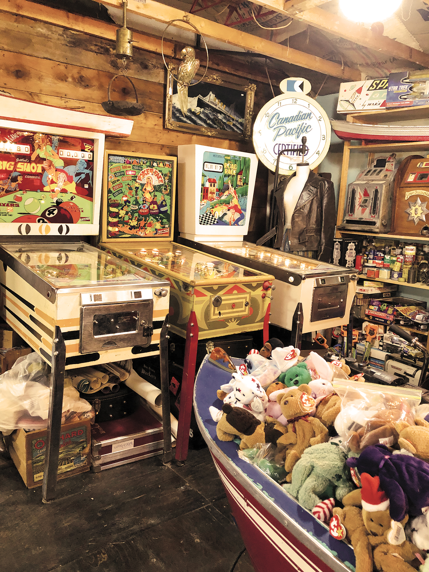 Antique pinball machines, stuffed beanie babies, Canadian Pacific clock, leather jacket. Antique pinball machines, stuffed beanie babies, Canadian Pacific clock, leather jacket.