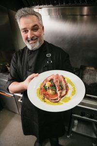 Chef Lino Oliveira with grilled octopus