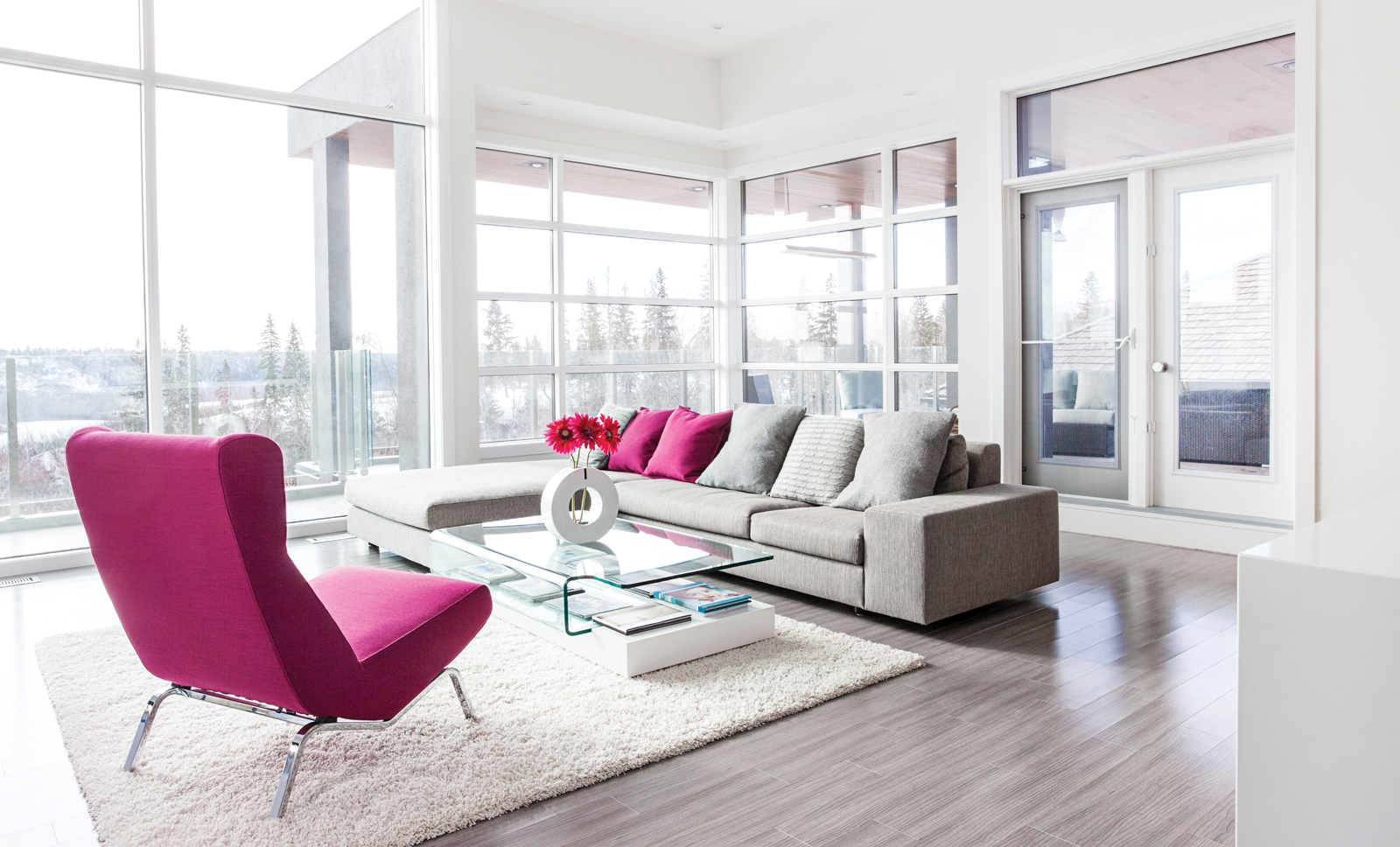 Ligne Roset sofa and chair from Dwell Modern; contemporary glass coffee table from Möbler Furniture; Lauzon Line Art Series hard maple flooring from Action Flooring