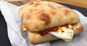 eggs and bacon breakfast sandwich on ciabatta bun