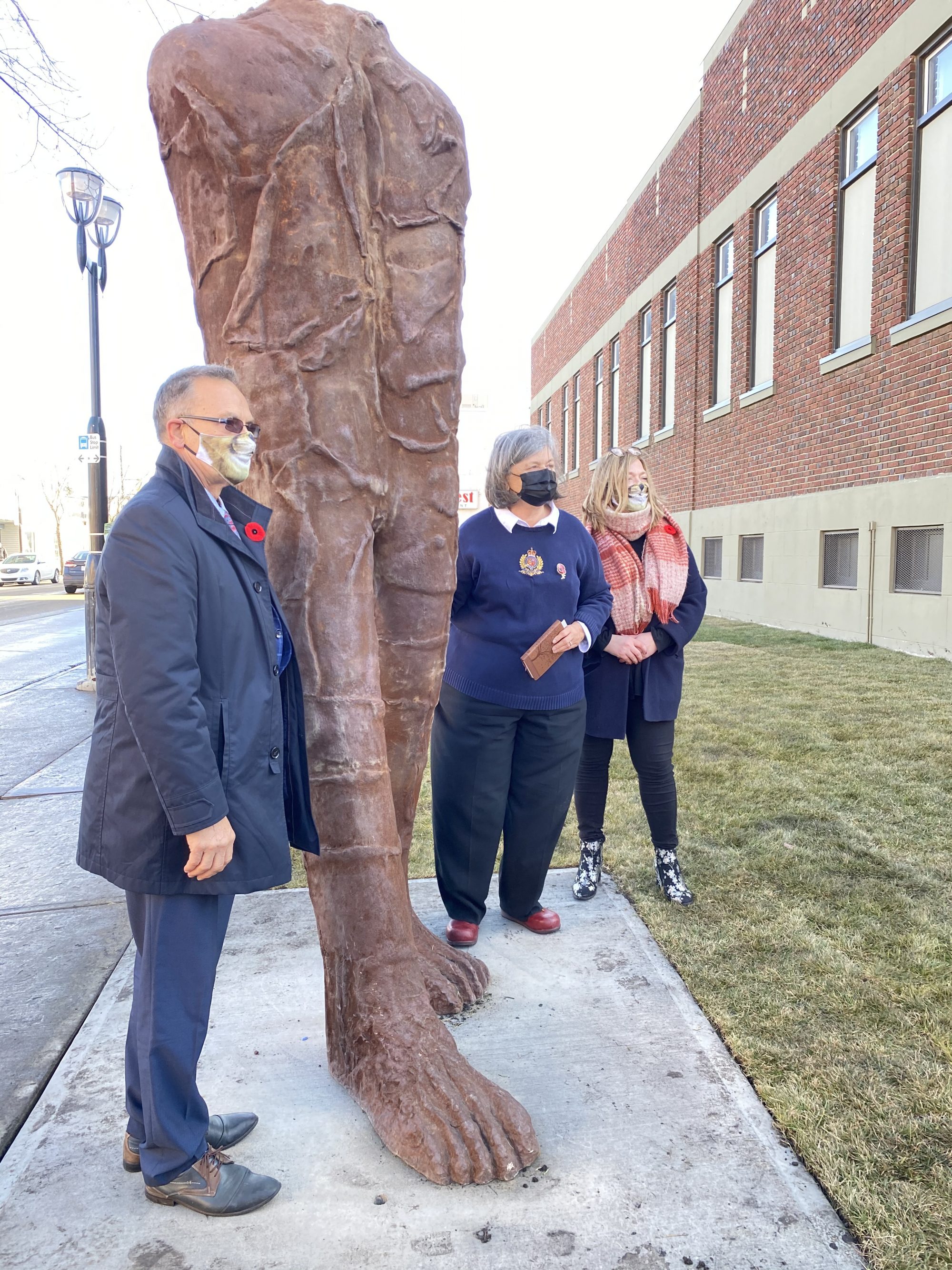 People standing with the sculpture