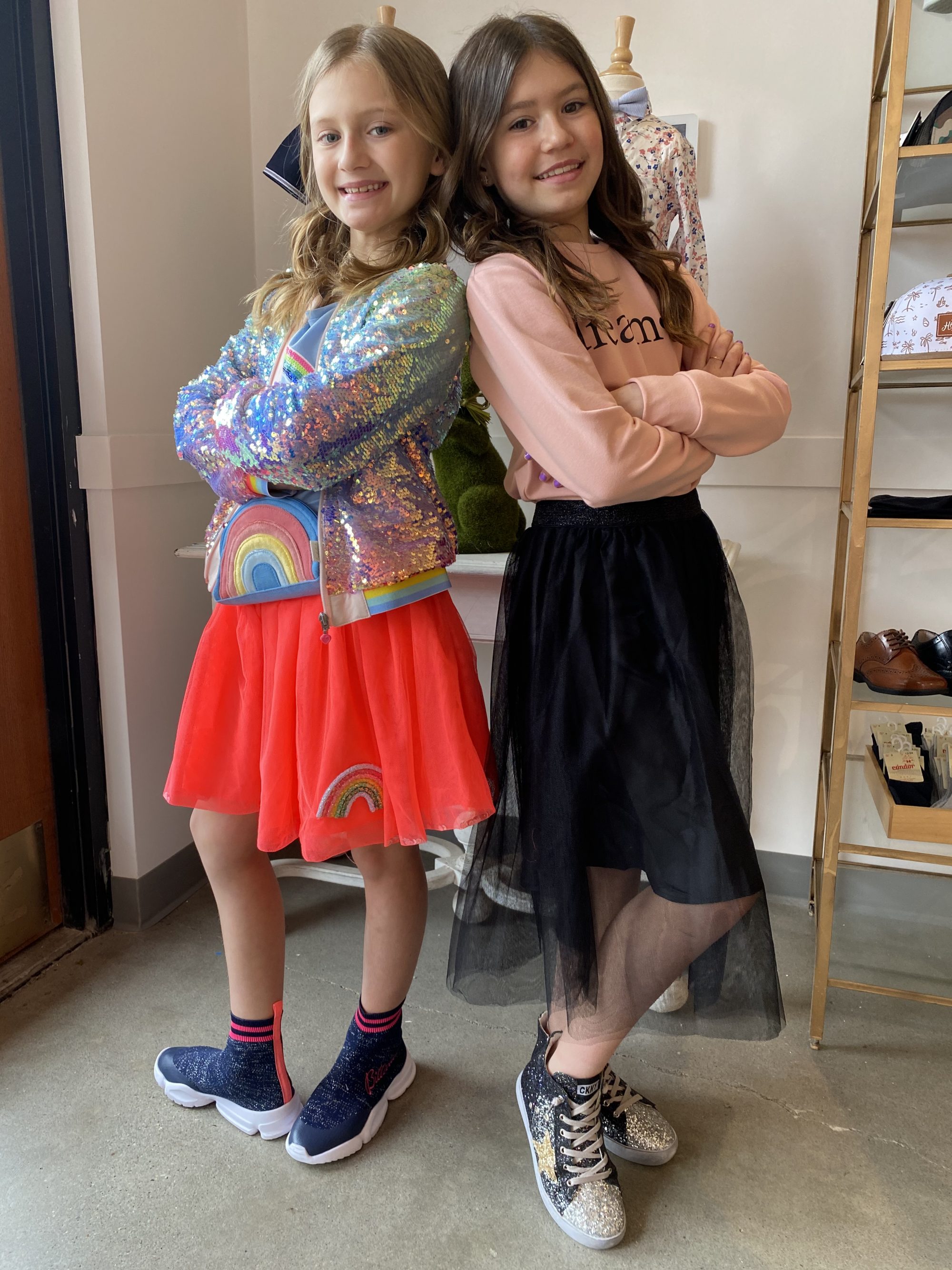 Two sisters posing in their outfits from Alligator Pie Kidswear in Edmonton