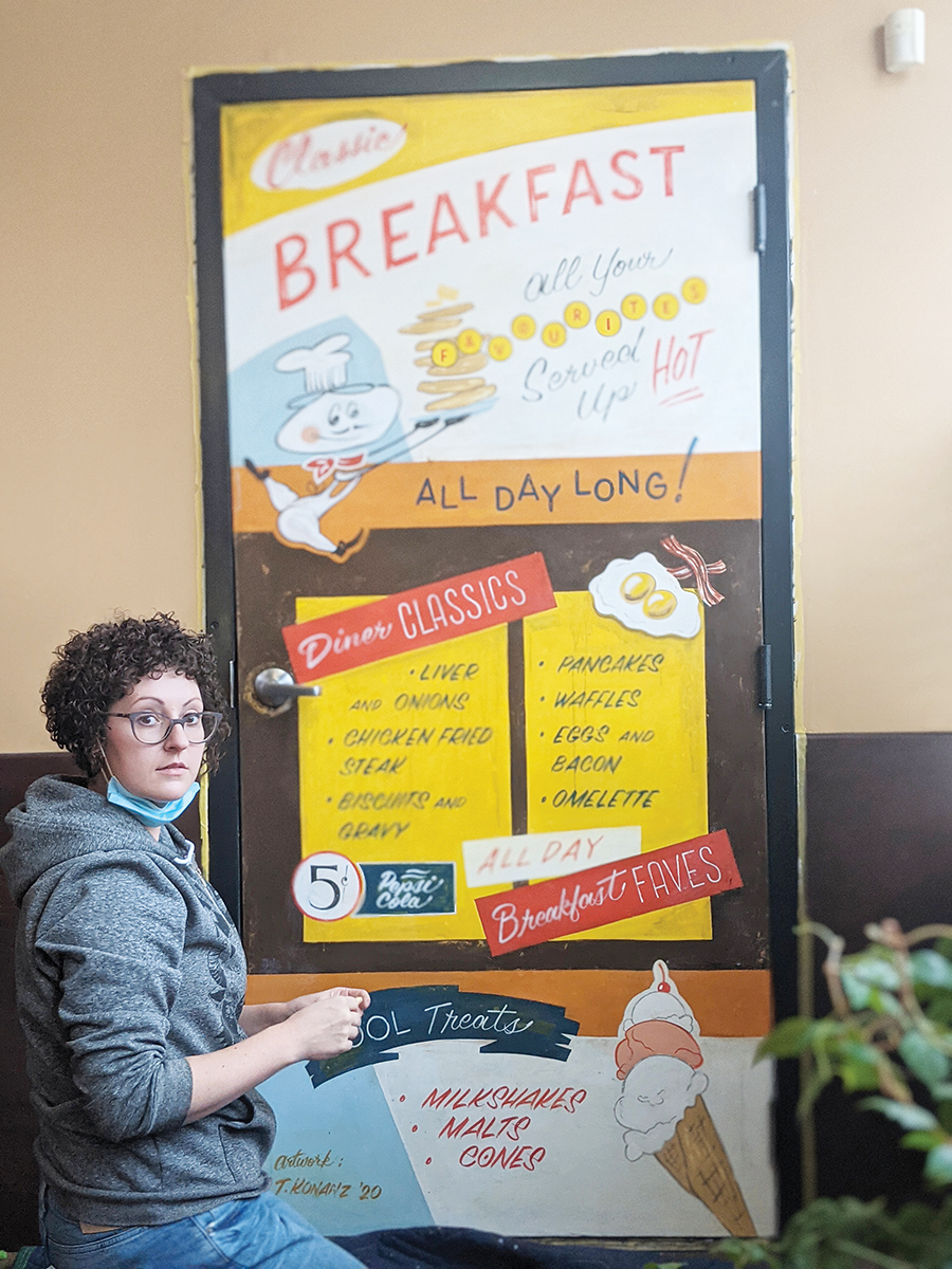 JenniferKonanzWithLargeBreakfastSign