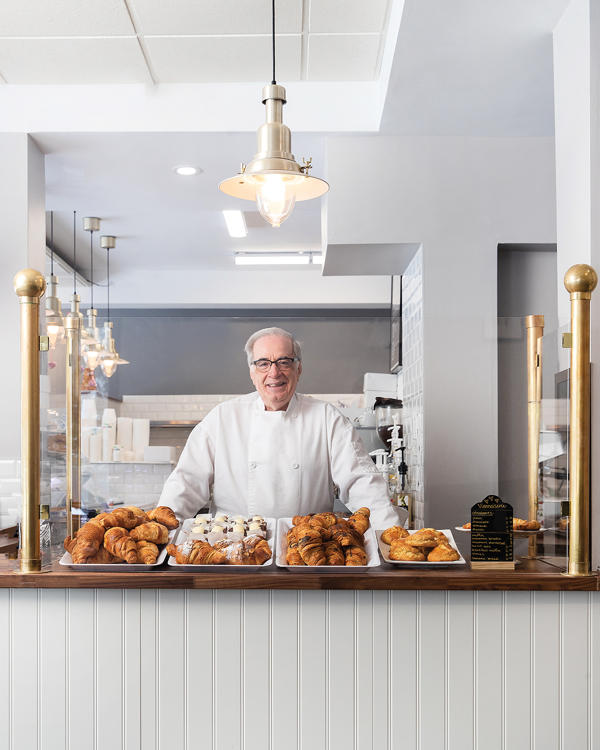 MOOD-AhmedDaoud_WhiteChefJacket_BehindCounterofBakedTreats