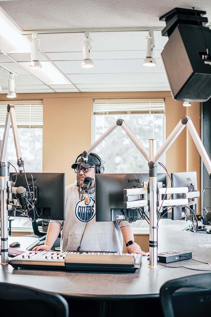 RavenRadio_BertCrowfootStandsBehindMike_RadioStation