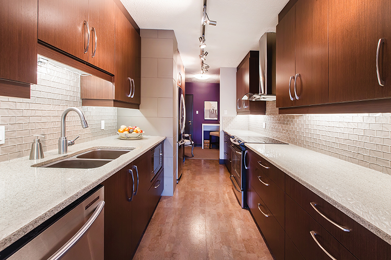 Beverly Sochatsky's condo has a divided kitchen space with clean, neutral tones. 