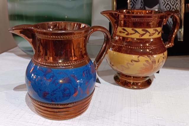 Two cream containers- compressed